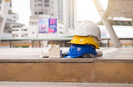 Hard hats safety helmet with home model,blueprint,Construction and Engineerの写真素材