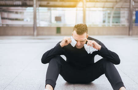 Sport man depression have a headache and feeling sadness outdoor