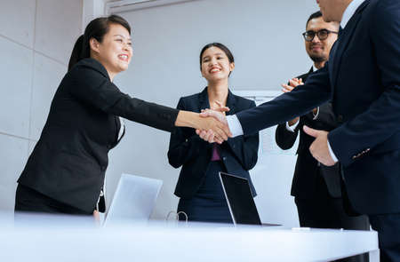 Business success team people shaking hands finishing up after meeting in officeの写真素材