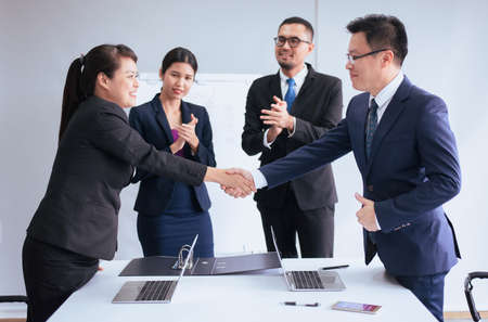 Business team people shaking hands finishing up meeting,Happy partnershipの写真素材