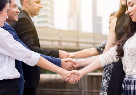 Business team people shaking hands finishing up meeting outdoorの写真素材
