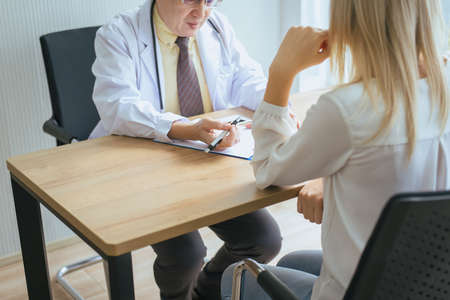 Man doctor examining to woman patient,Infertility counseling and suggestion using new technologyの写真素材