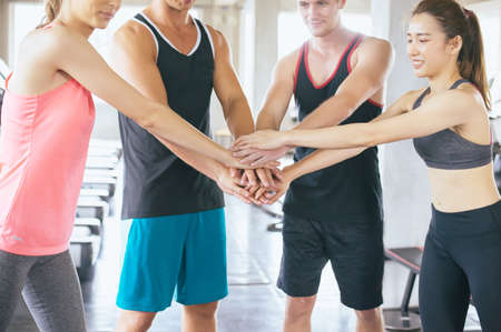 Group of diverse people hand coordination motivated,Sporty team attractive and holding or join hands...