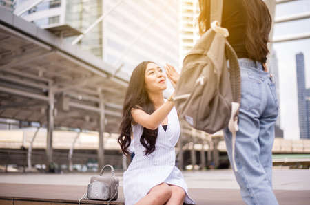 Young asian woman hands meeting,Happy greeting of two friend in the street