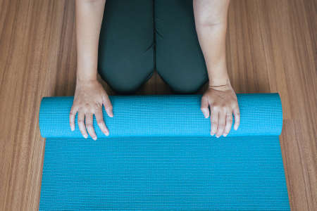Woman hand rolling or folding green yoga mat after a workout,Exercise equipment
Healthy fitness and sport conceptの写真素材