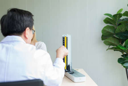 Man doctor checking to her patient blood pressure in hospital,Heart rate pressure gauge