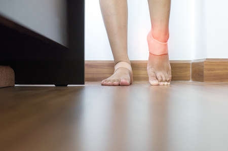 Woman using support silicone for treatment plantar fasciitis on her footの写真素材