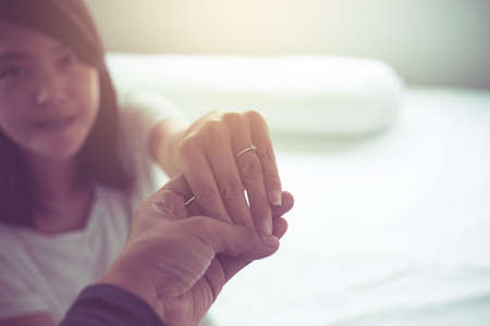 Asian couples lover holding hands to encourage in times of disappointment or life problems together,True friendship conceptの写真素材