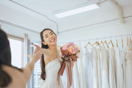 Happy bride asian woman smiling and cheerful with colorful flowersの写真素材