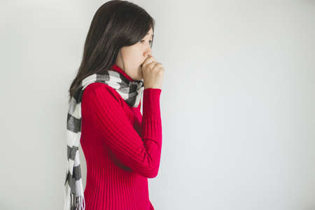 Asian woman coughing with sore throat,Female suffering with cough a lot on white background