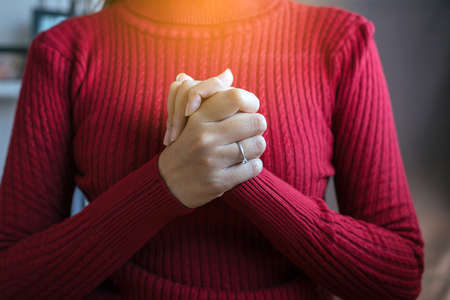 Woman with hand in praying position,Female prayer hands clasped together,Close upの写真素材
