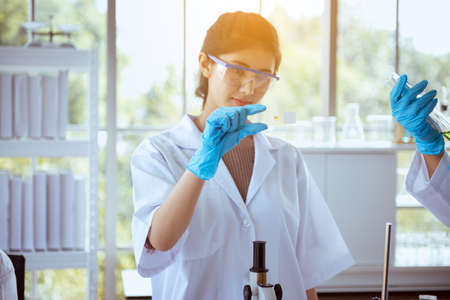 Biologist beautiful asian women research and working with medical chemicals sample test at...