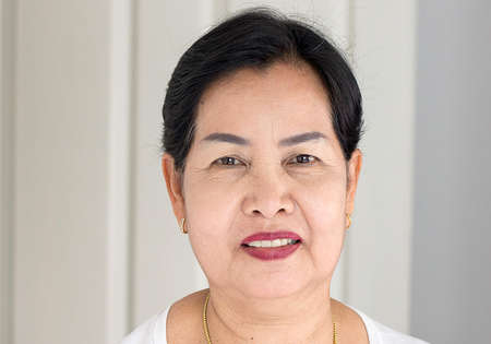 Portrait beautiful elderly asian woman in room,Senior female happy and smiling,Lifestyle concept,Positive thinking,Close upの写真素材