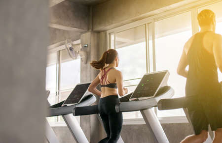 Woman running on treadmills doing cardio training in a gym,Healthy lifestyle concept