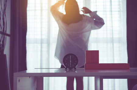 Blured of women stretch oneself and lazy in bedroom after waking up in the morningの写真素材