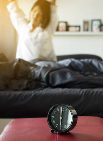 Blured woman stretch lazily in bedroom after waking up in the morningの写真素材