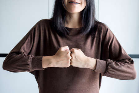 Hands of woman show strength teamwork,Fist bump and putting her handの写真素材