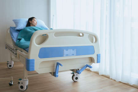 Blurred of beautiful patient asian women sleeping under blanket on sickbed at the hospitalの写真素材