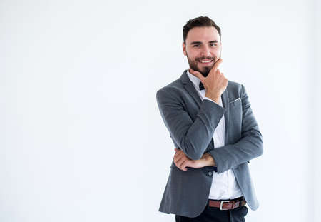 Young groom with bearded standing and smiling in formal tuxedo and suit in wedding day on white background,Copy space for textの写真素材