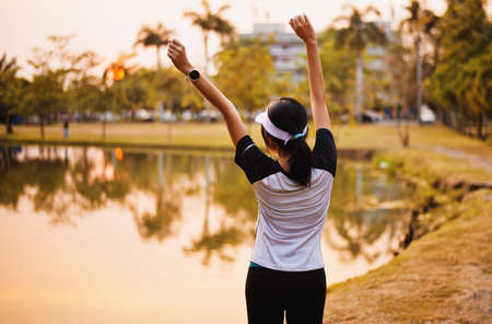 Happy asian woman enjoying and freedom with open hands in sunset,Female rise hands up enjoy nature...