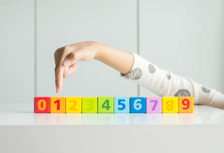 Hand woman pointing wood block 1,Concept of number 1 and top winner successの写真素材