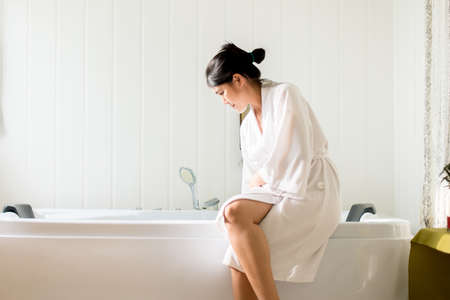Beautiful asian female filling up with water and relax in bathtub at hotel,Happy and smiling