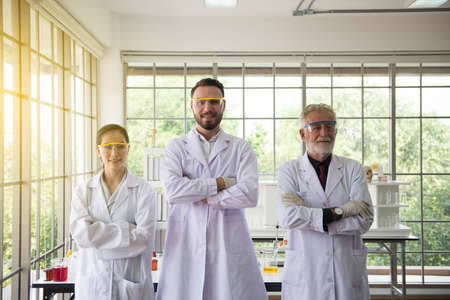 Group of scientists people standing and cross arms together in laboratory,Successful teamwork conceptの写真素材