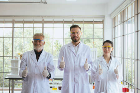 Group of scientists people standing and showing thumb up together in laboratory,Successful teamwork and reserch workingの写真素材