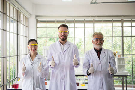Group of scientists people standing and showing thumb up together in laboratory,Successful teamwork and reserch workingの写真素材