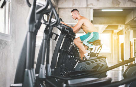 Healthy lifestyle concept,Sport man workout with cycling doing cardio training indoor centerの写真素材