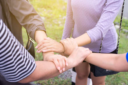Friends putting with stack of  handshaking and showing successful teamwork together,Close upの写真素材