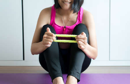 Woman using elastic for massage stretching finger cramp and painの写真素材