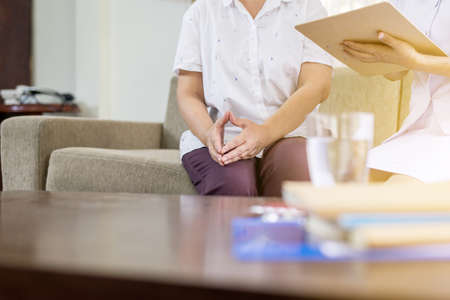 Professional psychologist writing note and consultation to senior woman patient, Suicide prevention, Positive attitude and open mind, Mental health care conceptの写真素材