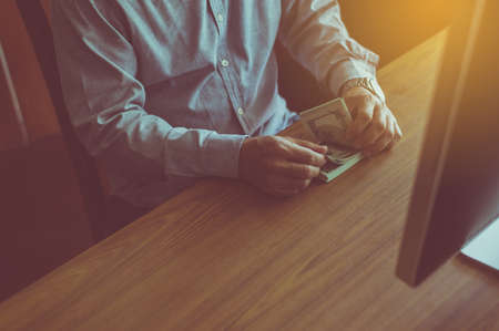Close up of man hands counting us dollar bills,Banknotesの写真素材