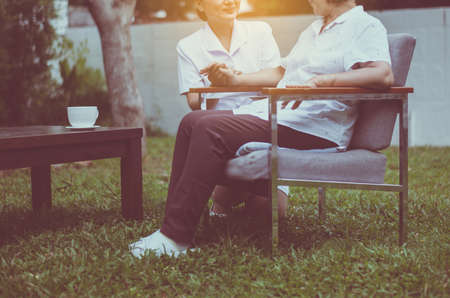 Senior patient woman hands holding with caregiver, Nursing home care concept, Close upの写真素材