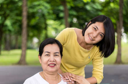 Happy and smiling senior asian mother with daughter at park,Take care support concept,Close upの写真素材