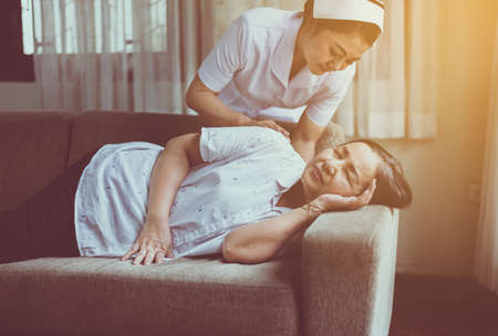 Nurse taking care of her patient mature asian elderly woman,Happy and smiling,Senior healthy conceptの写真素材