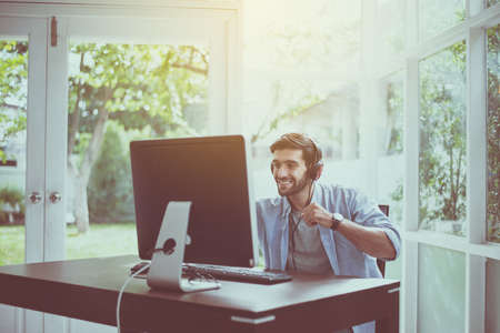 Sucessful man hands rais up with winner game online,Happy and smiling,Relax timeの写真素材