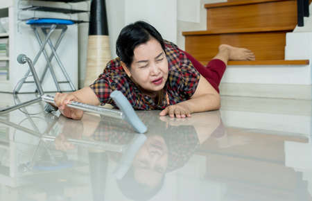 Senior asian woman suffering from falling down of staircase at homeの写真素材