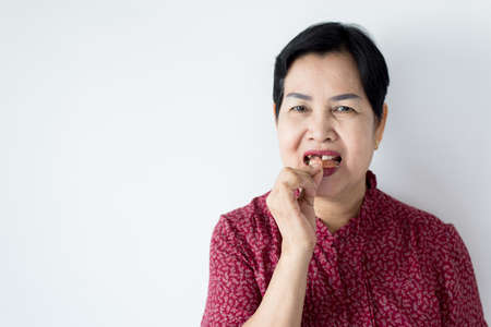 Senior asian woman is holding dentures in hands,Dental prosthesis,False teeth