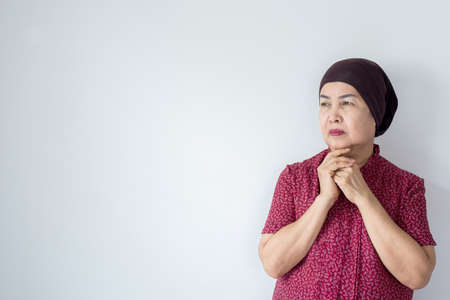 Senior asian woman with disease cancer standing on white background,Female felling depress and upset,chemotherapyの写真素材