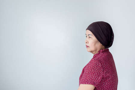 Senior asian woman with disease cancer standing on white background,Female felling depress and upset,chemotherapyの写真素材
