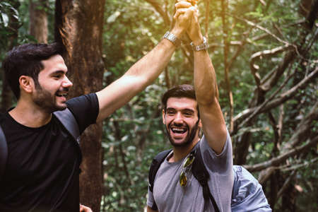 Happy traveler man standing and hand clamping together,Enjoying backpacking conceptの写真素材