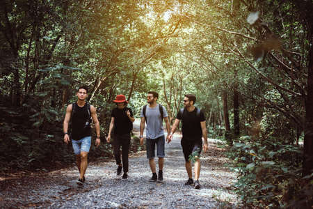 Group of traveler friends walking together at rain forest,Enjoying backpacking concept