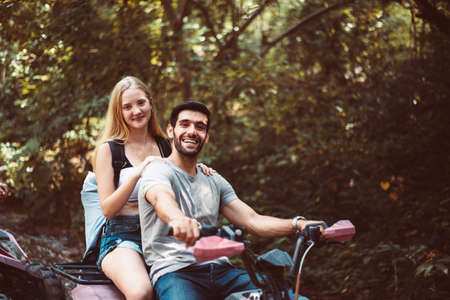 Couple lover driving off-road and sitting on ATV together,Happy and fun