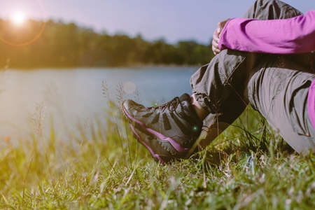 Hiker tfemale sitting at nature,Hiking shoes woman in beautiful view,Close upの写真素材