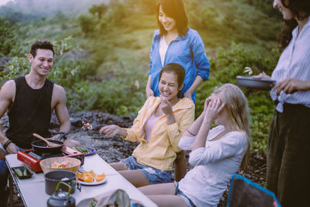 Cheerful of diversity best friends cooking food for breakfast at outdoor together,Enjoying camping conceptの写真素材