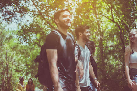 Group of traveler best friends walking together at rain forest,Enjoying backpacking conceptの写真素材