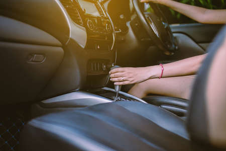 Woman driving hand using car automatic gear,News technology gear shift system in carの写真素材