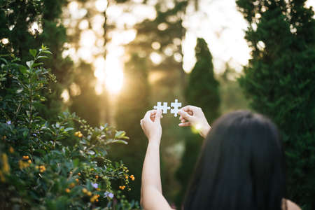 Hands woman connect couple puzzle piece together with sun light,Business success and strategy...